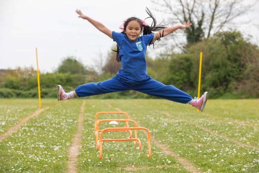 Girl jumping in a field