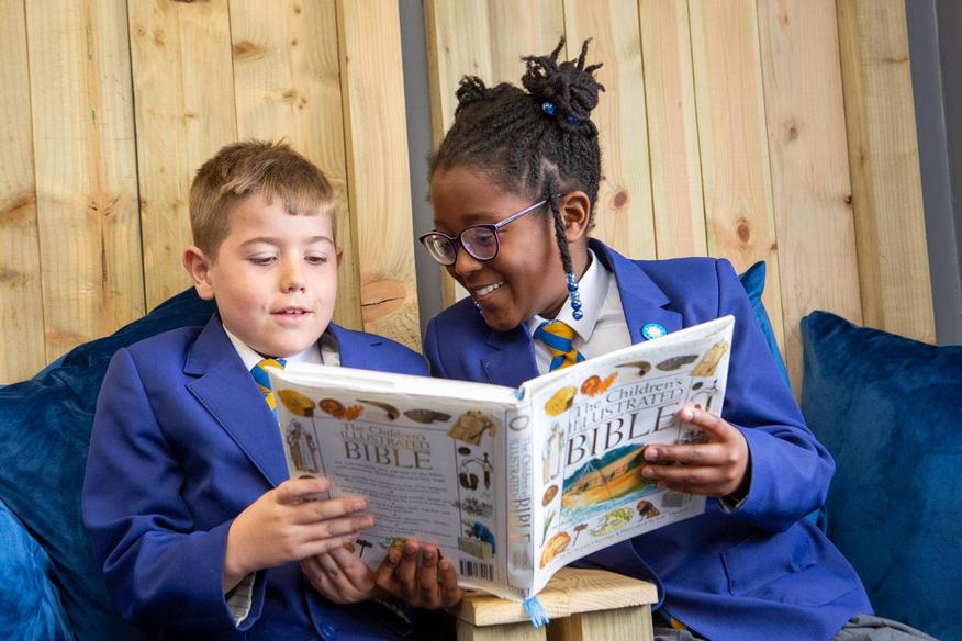 Two children reading a book