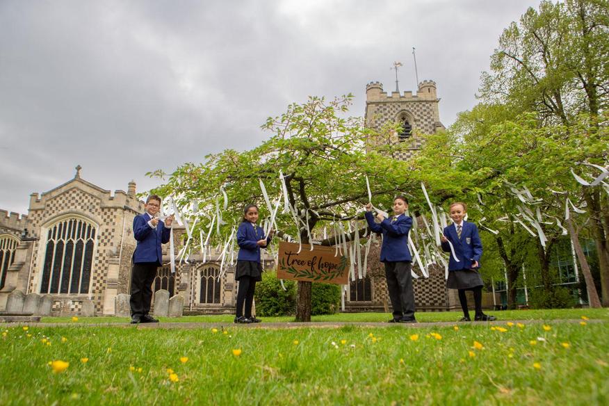 children next to the tree of hope